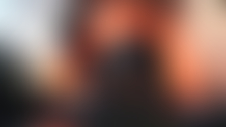 A large building is engulfed in flames and thick smoke, set against a cloudy sky. Intense fire and smoke create a dramatic scene.