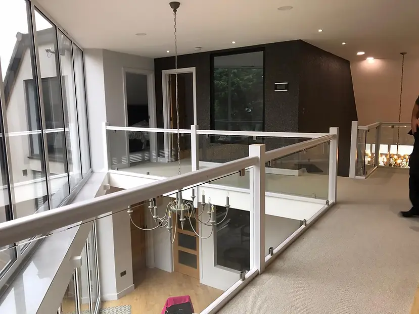 White banister with glass infills in modern home
