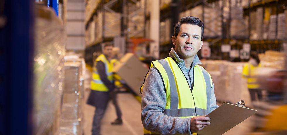 A man in a hi-vis jacket in a warehouse