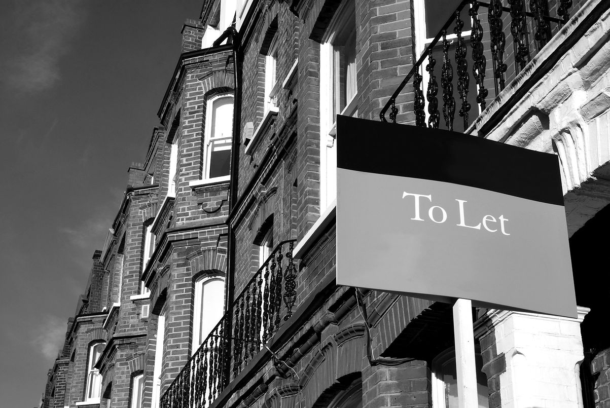 A typical red-brick townhouse with a To Let sign