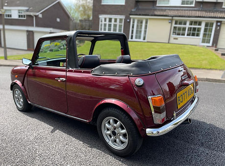A cherry red metallic mini convertible.jpg
