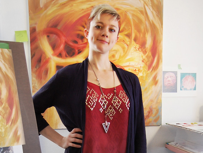 Portrait of Nicole Cooper in front of painting