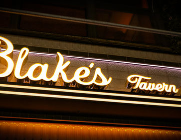 Illuminated Blake's Tavern NYC sign at night