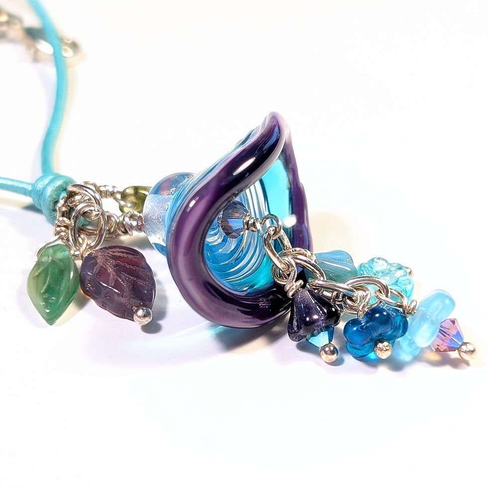 aqua swirled purple edged lampwork flower pendant with wire wrapped flower dangles front right angle view