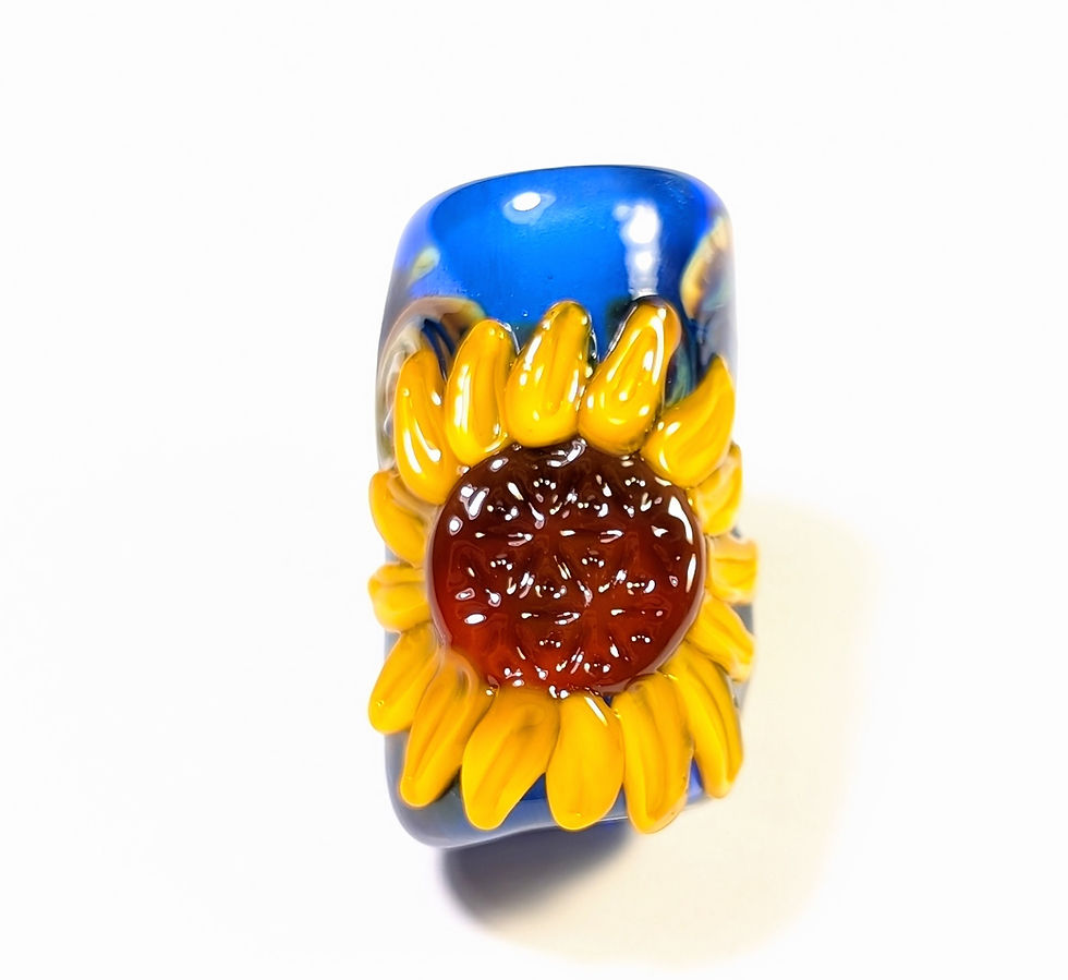 Thumbnail: blue lampwork dread bead with a sunflower and a flower of life center front view