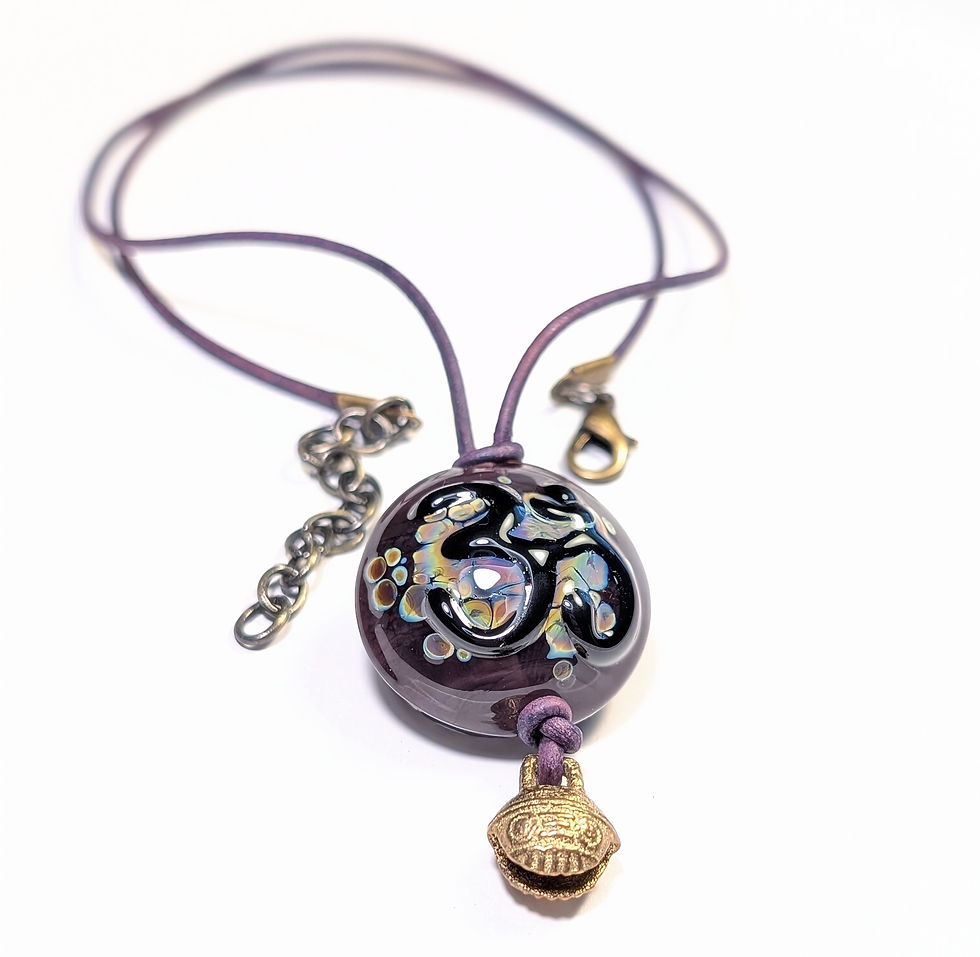 Thumbnail: Glass purple om with tibetan bell necklace front angle pendant close up view