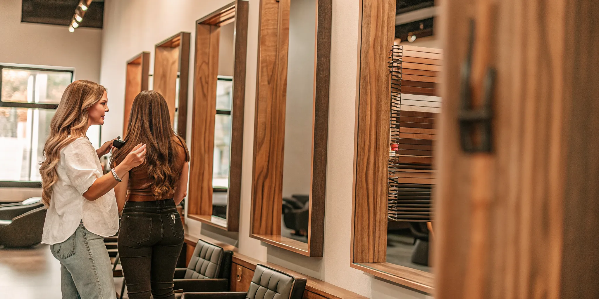 Hair extensions tacoma consultation at Dolce Salon matching length and shade in the mirror