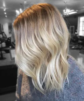 Blonde hair extension transformation with long softly waved layers