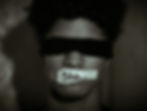 closeup of man with a blindfold on and Shh taped over his mouth