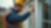Eye-level view of a home inspector examining a house exterior