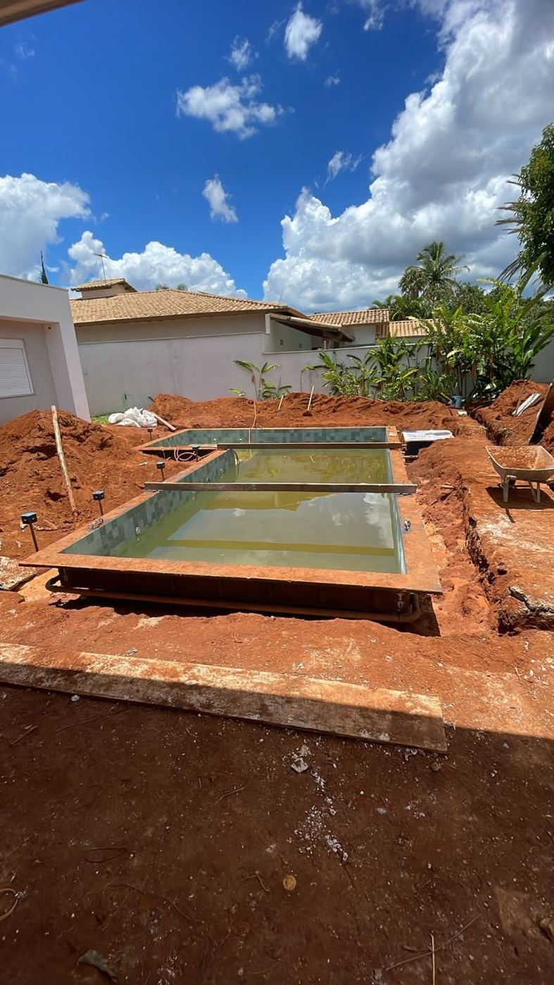 Piscina recém-assentada no terreno durante a obra em Brasília