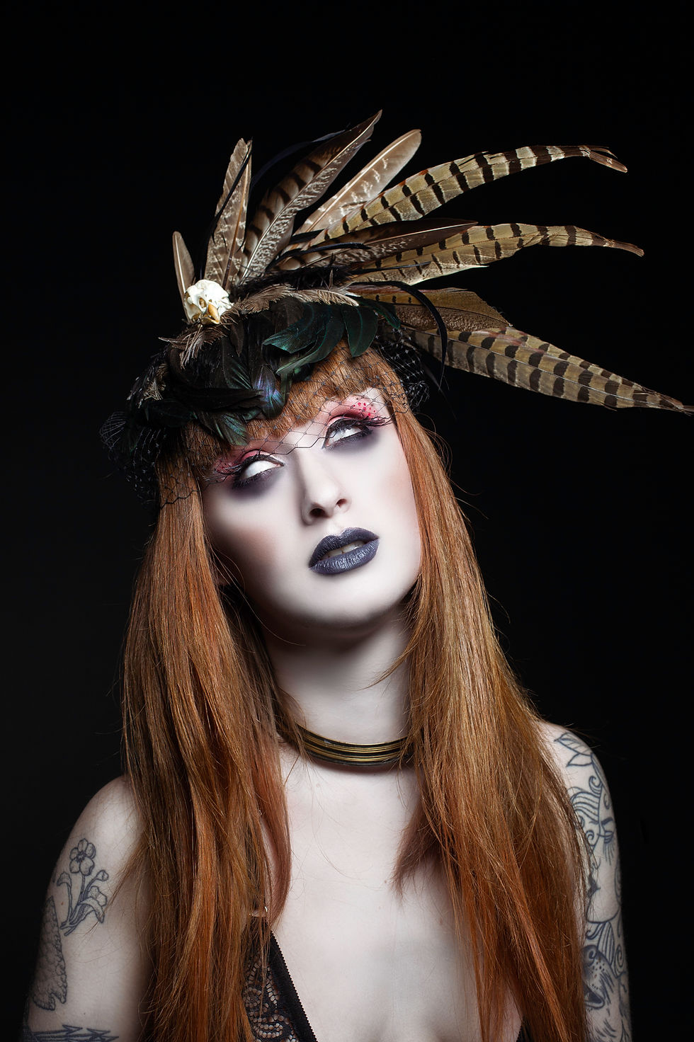 Thumbnail: Model wearing handmade feather fascinator with dramatic sculptural plume