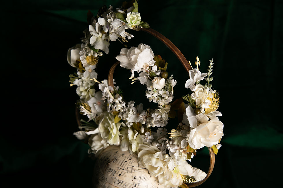 Thumbnail: Close-up of ivory flowers and botanical details on sculptural headdress