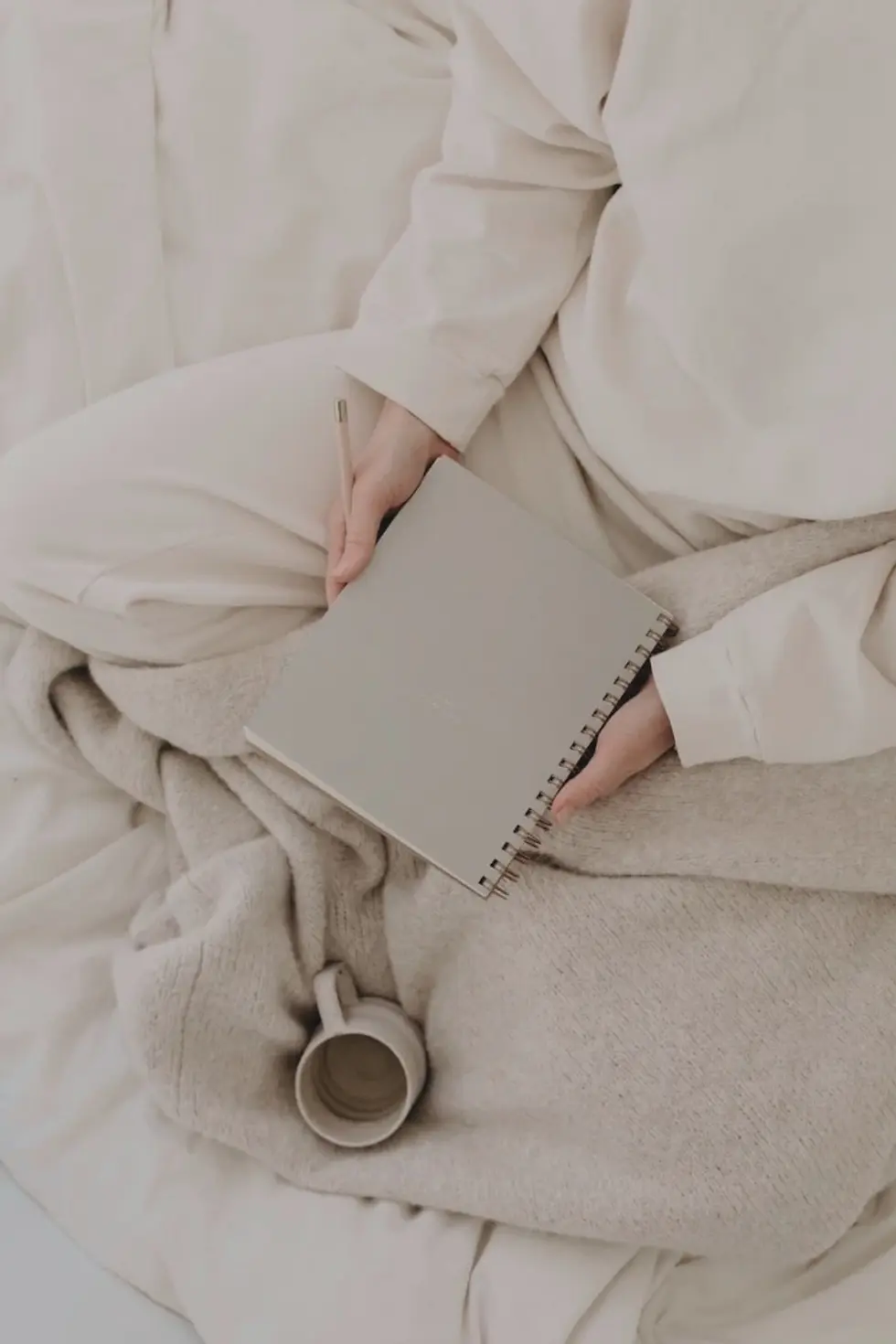 holistic lifestyle - woman in white journaling