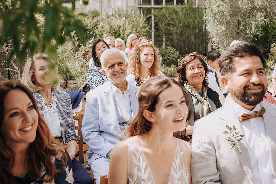Happy bride and guests at spring wedding ceremony