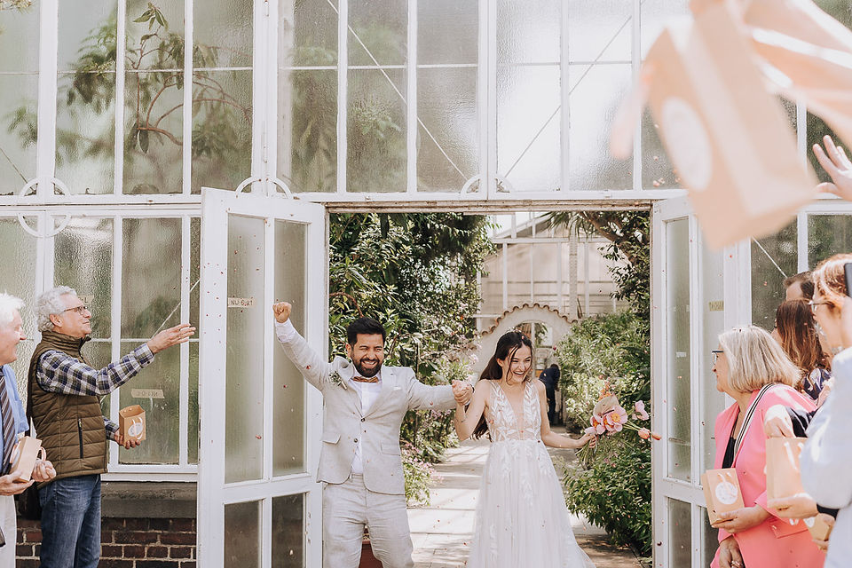 Joyful couple exits Berlin Botanic Garden wedding