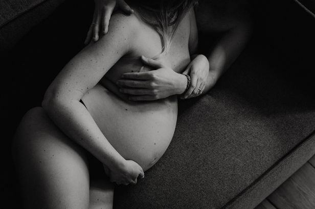 Black and white maternity photo, tender embrace