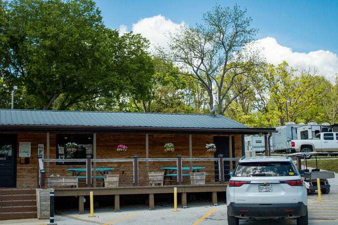 Building with tables, a car, and trees; rv parks in joplin missouri