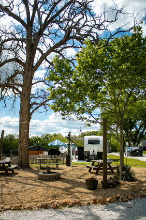 RV park campground with picnic tables, trees, and sunny day, rv parks in joplin missouri