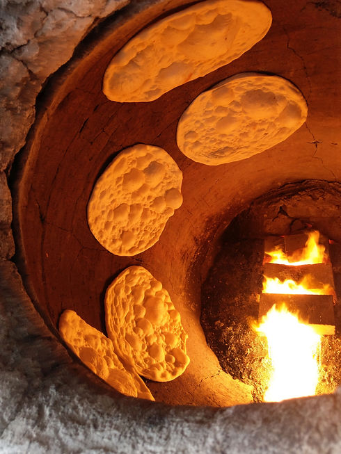 Iraqi bread in clay oven.jpg