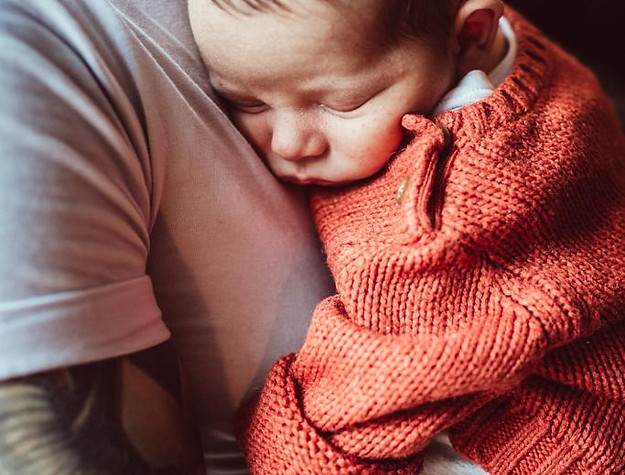 Dad cuddling new born baby at Bump to Baby Group Frome