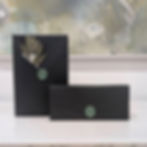 Two Wrapped Gift Boxes with the Letter N Wax Seal on them