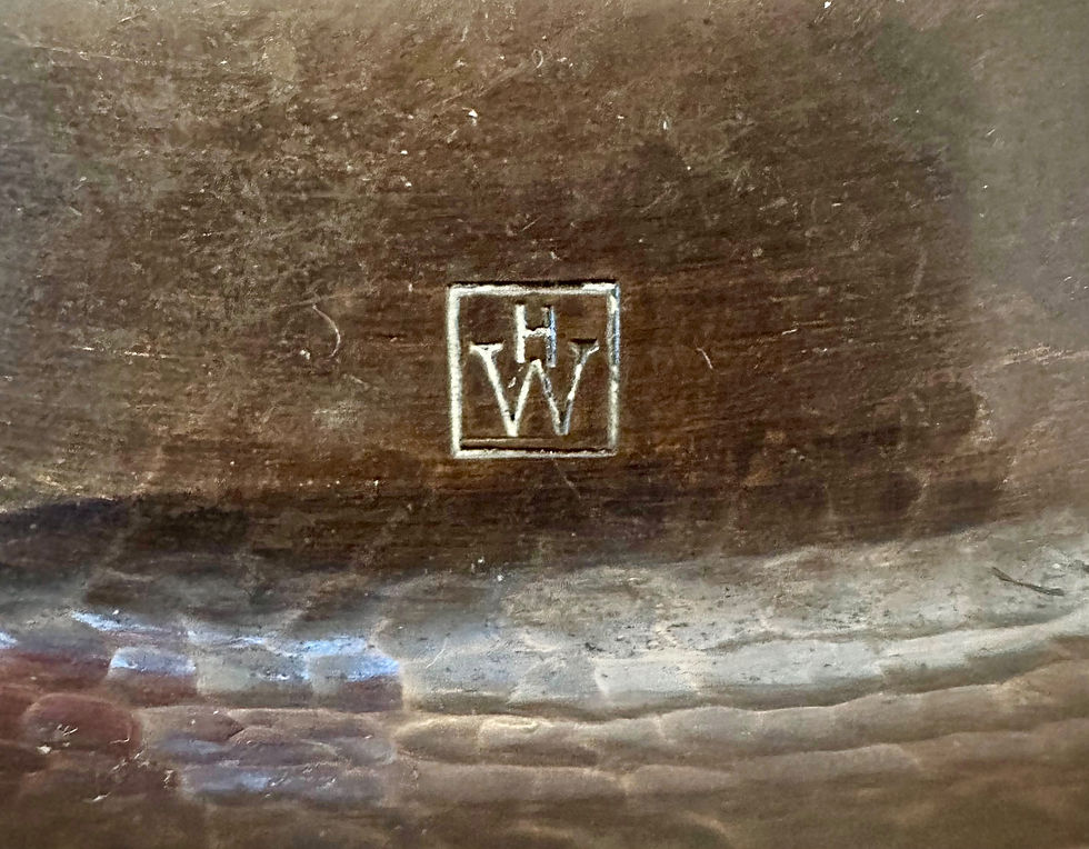 Close-up of the HW maker's mark on an Arts and Crafts copper plate attributed to Hugh Wallis.