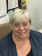 School secretary sitting at desk.