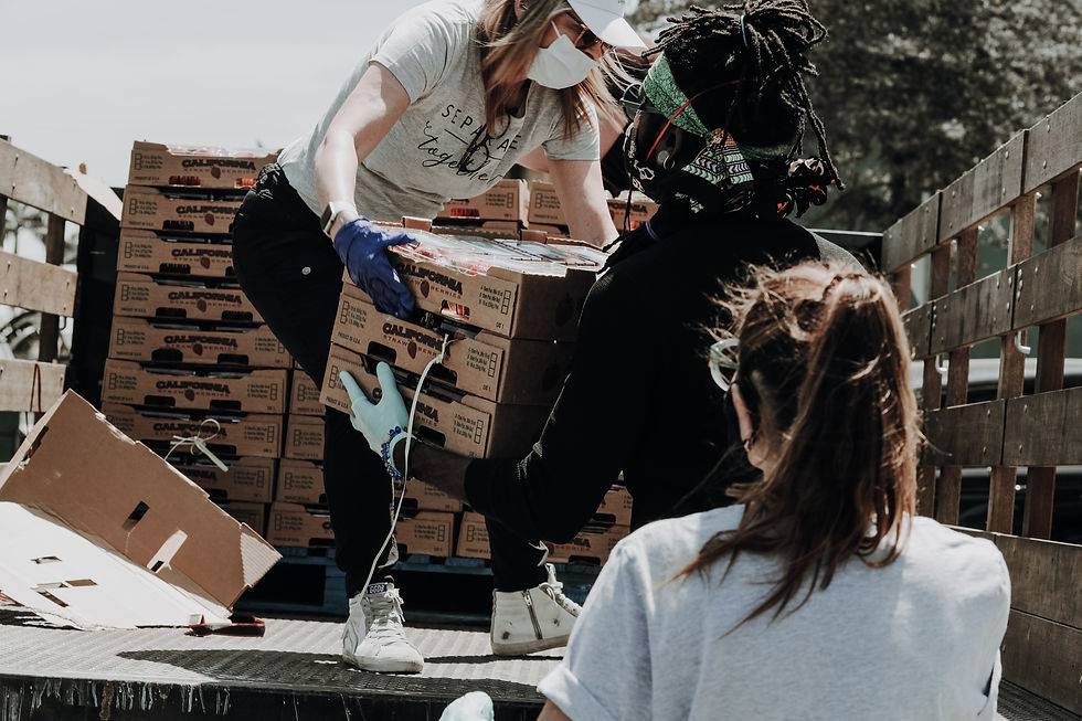 Woman handing a man a box of fruit