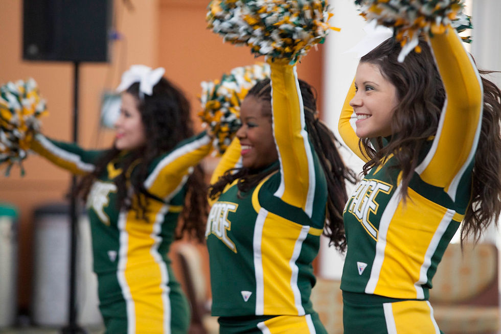 Cheerleaders smiling and cheering.