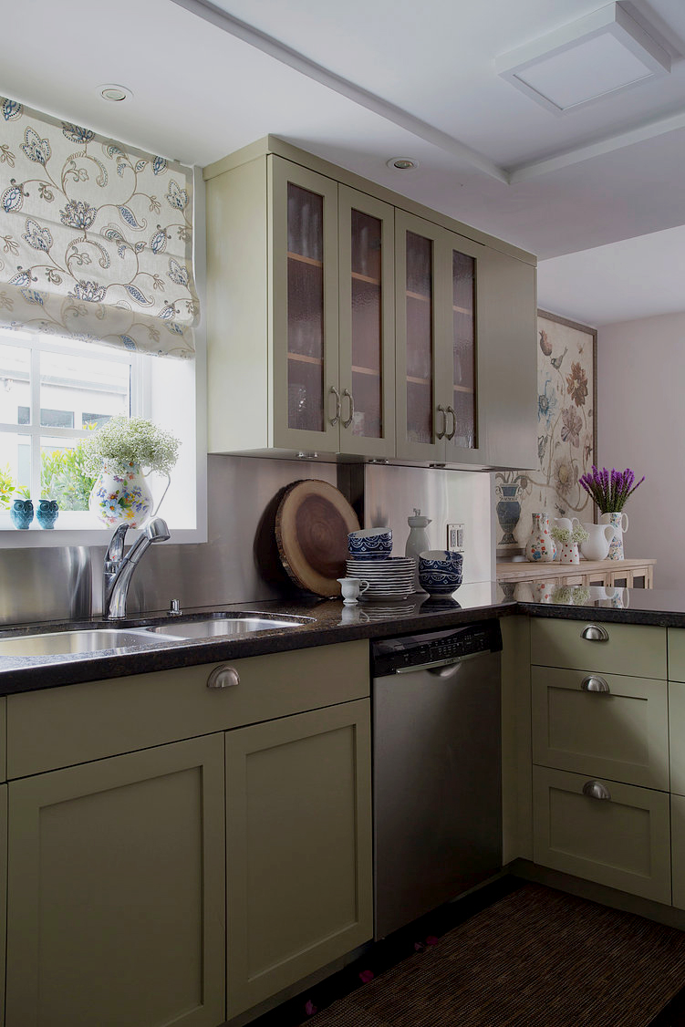 The Ubatuba Countertops and the cabinets were kept because the owner was afraid a new kitchen would look too modern," Saliba explains, adding that the cabinets were originally a cherry hue. The window valance was made with an embroidered fabric from Wall Boutique.