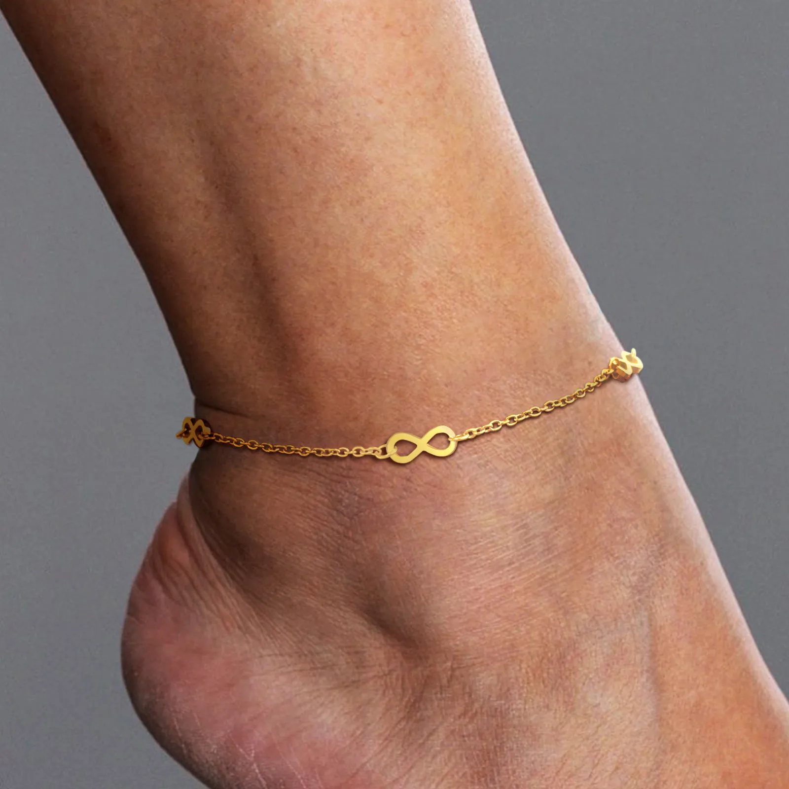 leg showcasing infinity symbol gold plated anklet
