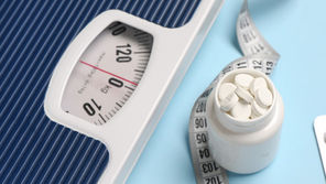 Scale with pills and tape measure