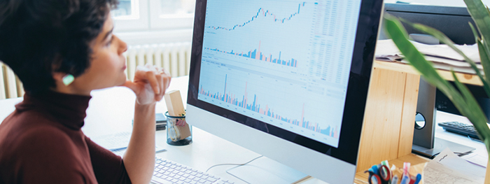 Woman analyzing growth charts on a computer screen