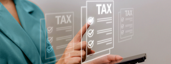 Person interacting with digital tax forms on a screen.