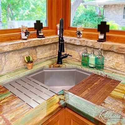 Kitchen sink and countertop with faucet Rachiele, natural light and decor.