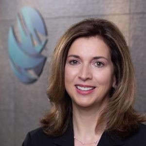 Professional portrait of a smiling woman in a dark blazer