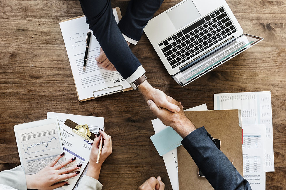 Overhead view of professionals shaking hands over a desk