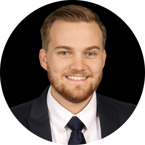 Smiling man with beard in suit and tie headshot