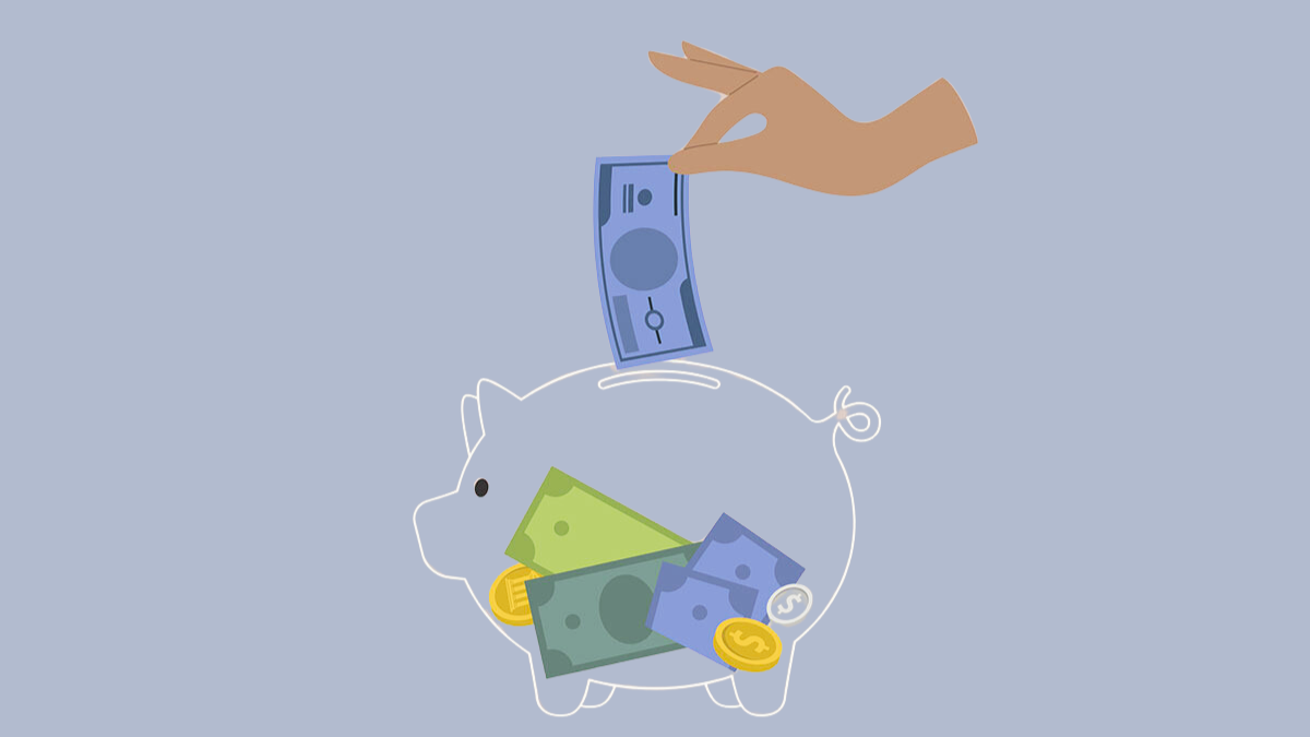 Hand putting a dollar bill into a clear piggy bank.