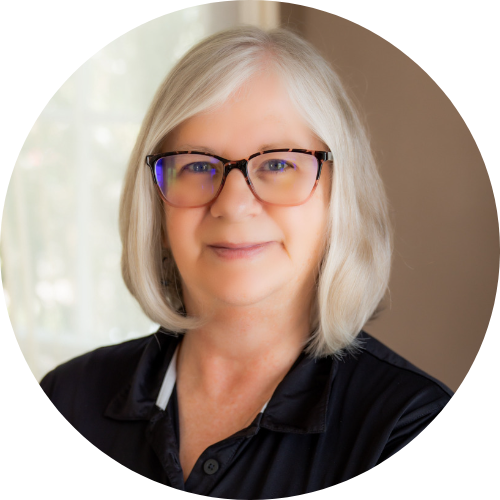 Smiling woman with blonde hair and glasses in a circle crop
