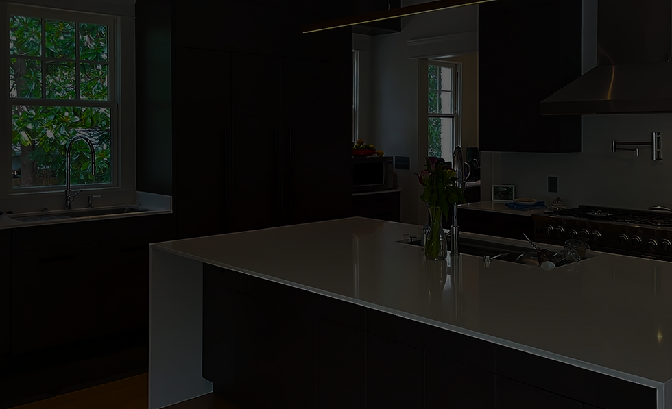 Modern kitchen design with large island, dark cabinets, and bright countertops Rachiele.