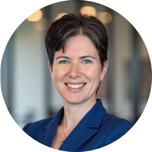 Smiling woman with short dark hair in a blue blazer.