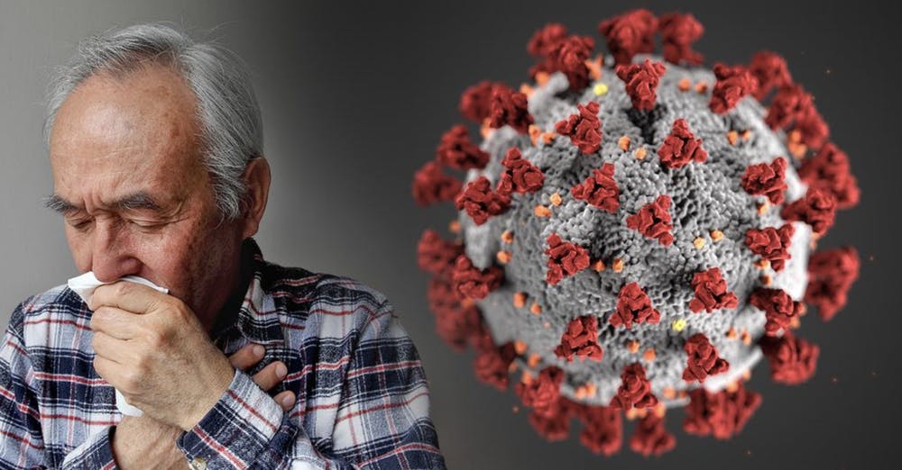 Senior man coughing next to a large coronavirus model