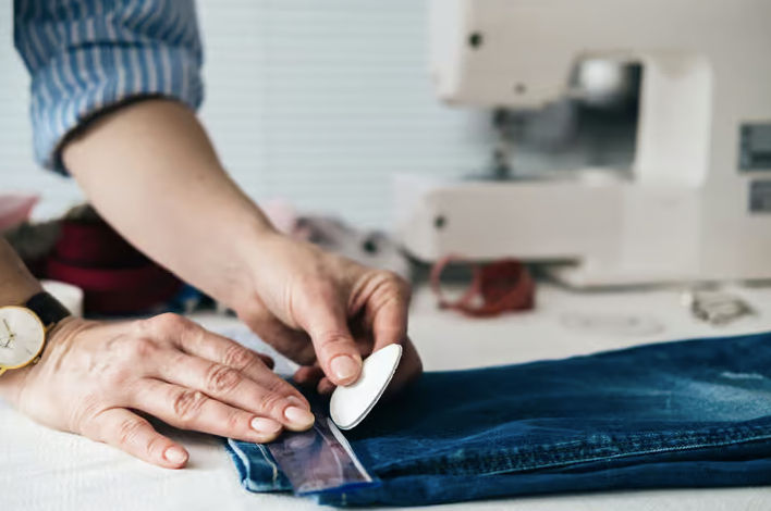 Mobile tailor fitting and pinning clothing for alterations in Los Angeles