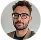 Man with dark hair, glasses, and beard