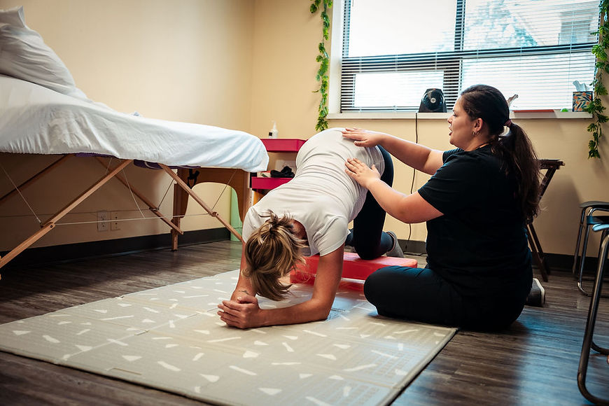 Pregnant mom doing inversions during pelvic floor physical therapy in Waukesha, WI