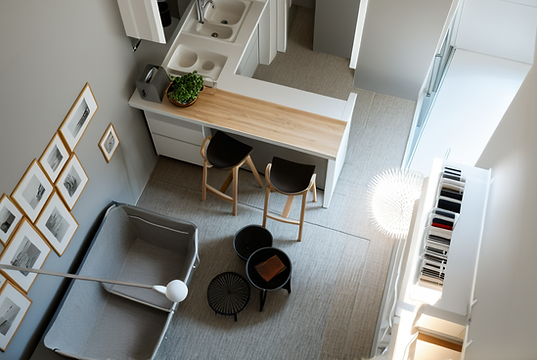 Vista dall'alto di un soggiorno open space con angolo cottura e bancone con sgabelli: render
