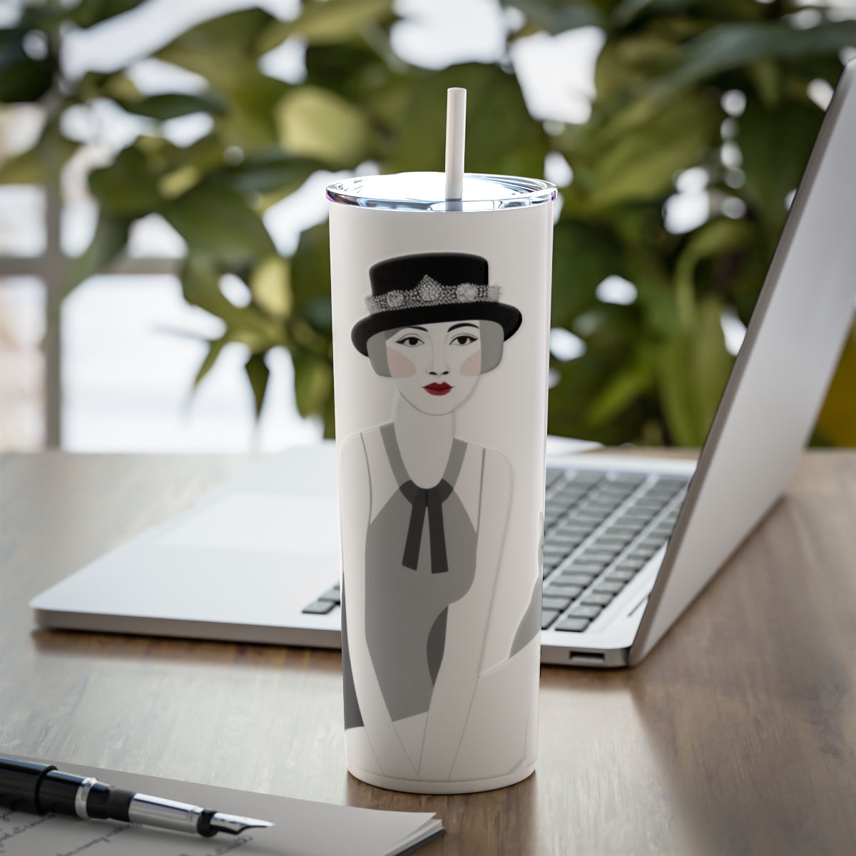 Retro art deco tumbler next to a laptop