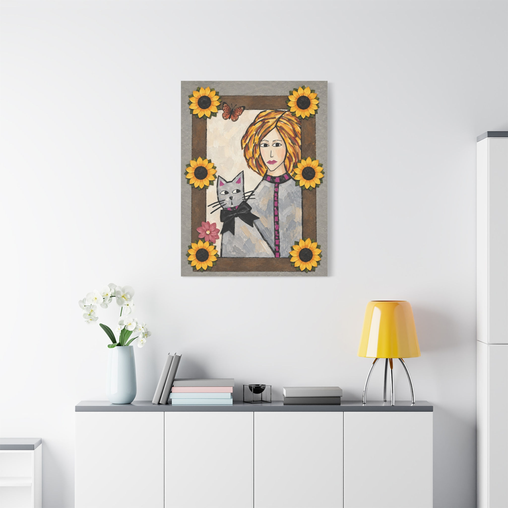 Woman and cat art print in a minimalist room with floral accents